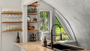 A kitchen with a window, shelves with glasses and bottles, and a sink. - The Iconic Vail Dome, 7 Bedrooms in Vail (Vail)