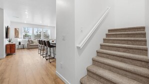 A modern living room with a sofa, chairs, and a coffee table. - Near Eagle Island | Pool | 2 King Beds | Parking | Smart TV (Eagle)