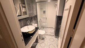A modern bathroom with a large sink, toilet, and shower. - steelbutikotel (Kocasinan)
