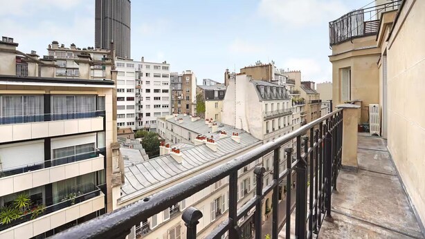 A high-rise building with a modern design, featuring multiple balconies and a mix of architectural styles. - Top floor Saint Germain Terrace Apartmrent (Paris)