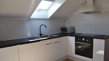 Apartment | Private kitchen | Fridge, microwave, stovetop, cookware/dishes/utensils