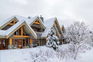 A multi-story lodge with a symmetrical roofline, large windows, and wooden beams. - Charming 4BR/5BA on Golf Course w/ Private Garage (Whistler)