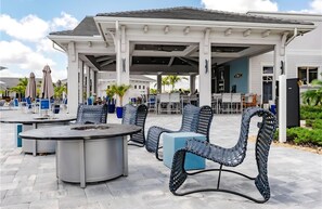 Outdoor dining - Charming lakeside home with pool, spa  and modern coastal design. (Ave Maria)