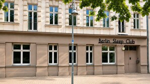A building with a sign reading 'Berlin Sleep Club' and a number '7' above the entrance. - Berlin Sleep Club (Berlin)