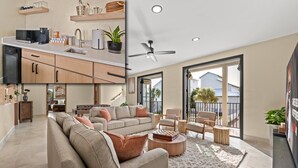 A modern living room with a sofa, coffee table, and chairs. There is a kitchen area with a microwave, coffee maker, and cabinets. The room has a large window and a ceiling fan. - Gulf views, Saltwater lagoon & waterfall, Beach@2min walk, Firepit, Golf Cart, Elevator (Destin)