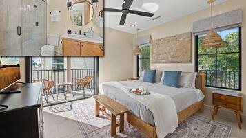 Une chambre moderne avec un grand lit, un balcon avec coin salon extérieur, un espace douche et une vue sur la verdure.