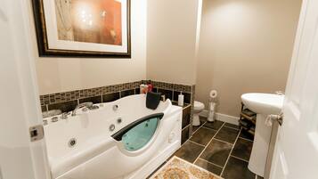 A modern bathroom with a freestanding bathtub, a toilet, and a sink.