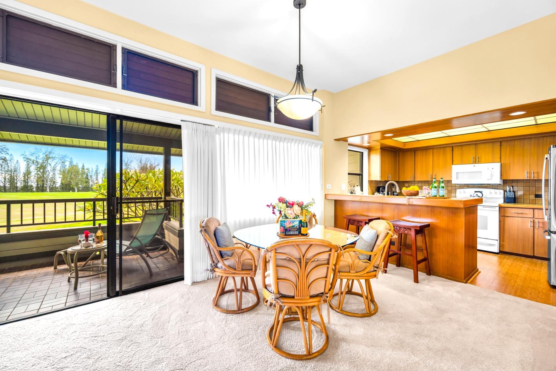 Your dining area sits just off the kitchen and lanai, with garden views and breezy natural light.