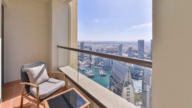 A balcony with a view of a marina and high-rise buildings. - Luxury 3BR JBR · Shams · Free 5* Beach Resorts Access! (Dubai)