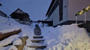 A snow-covered staircase leading up to a building.