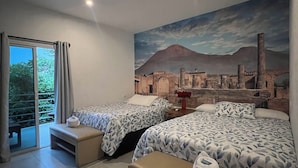 A hotel room with two beds, a large mural of a cityscape, a sliding glass door to a balcony, and a bench. - Hotel Villa Napoli (Santa Ana)
