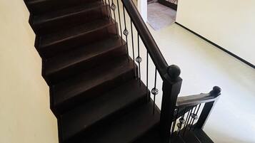 A staircase with dark wooden steps and black metal railings.