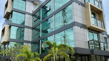 A modern building with multiple floors, large glass windows, and a sign reading 'AQUA LUNA'.