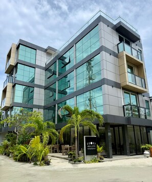 A modern building with multiple floors, large glass windows, and a sign reading 'AQUA LUNA'. - Aqua Luna Dhangethi (Dhangethi)