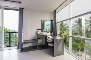 A modern kitchen with a large window, a countertop, and a chair. - Aqua Luna Dhangethi (Dhangethi)