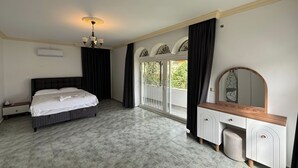 A bedroom with a bed, a dresser, a mirror, and a window with curtains. - Mete 3 Villa İçmeler Weekly Daily Rentals (Marmaris)