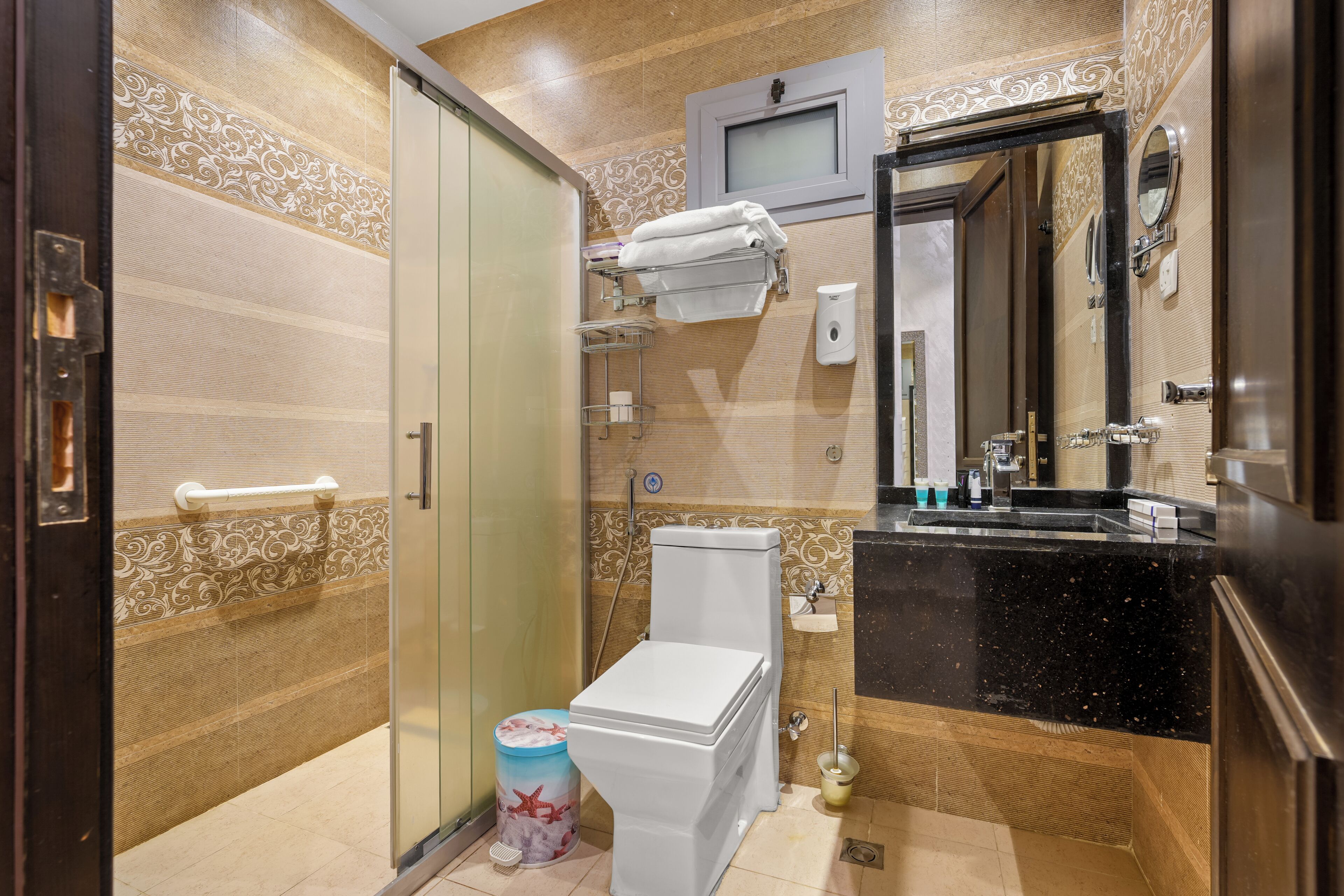 A modern bathroom with a toilet, sink, and shower area.