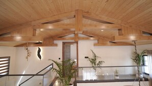 A spacious interior with a high wooden ceiling, a staircase, and potted plants. - Escape to Amber Moon – Private Luxury Villa in Kumarhatti (Dharampur)