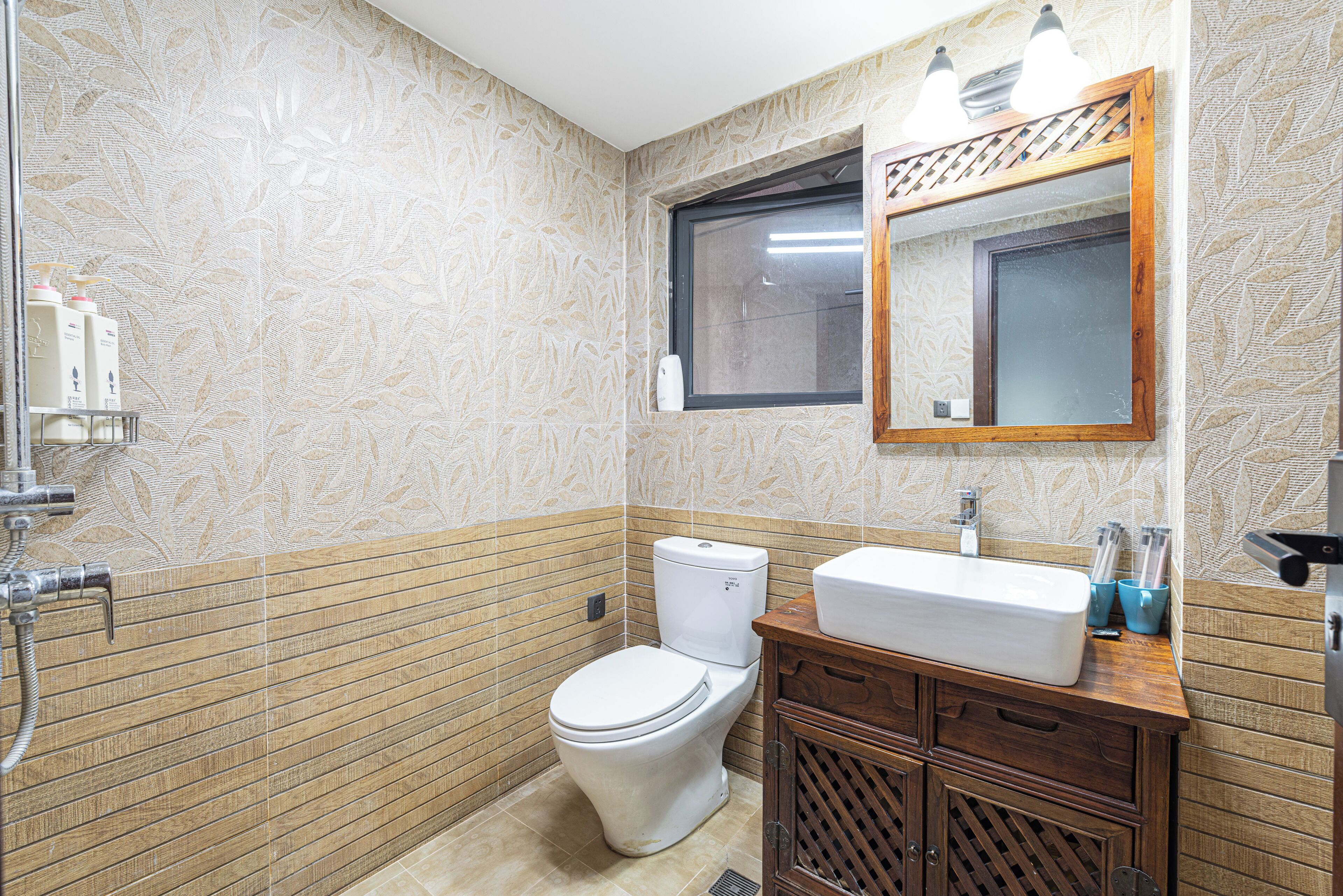 A bathroom with a toilet, sink, and shower.