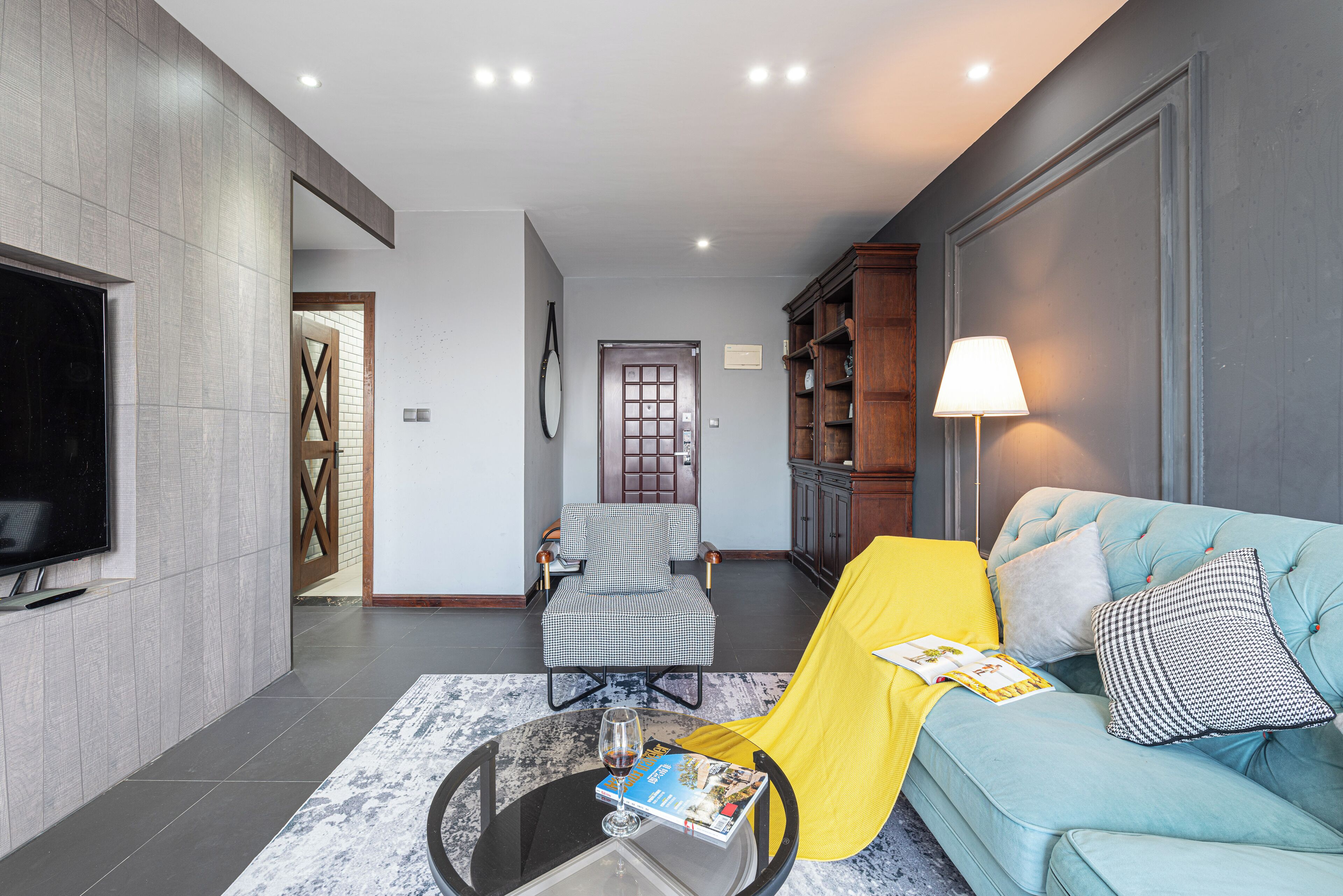 A modern living room with a sofa, armchair, and coffee table.