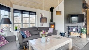 Ein modernes Wohnzimmer mit einer Couch, einem Couchtisch und einem Kamin.