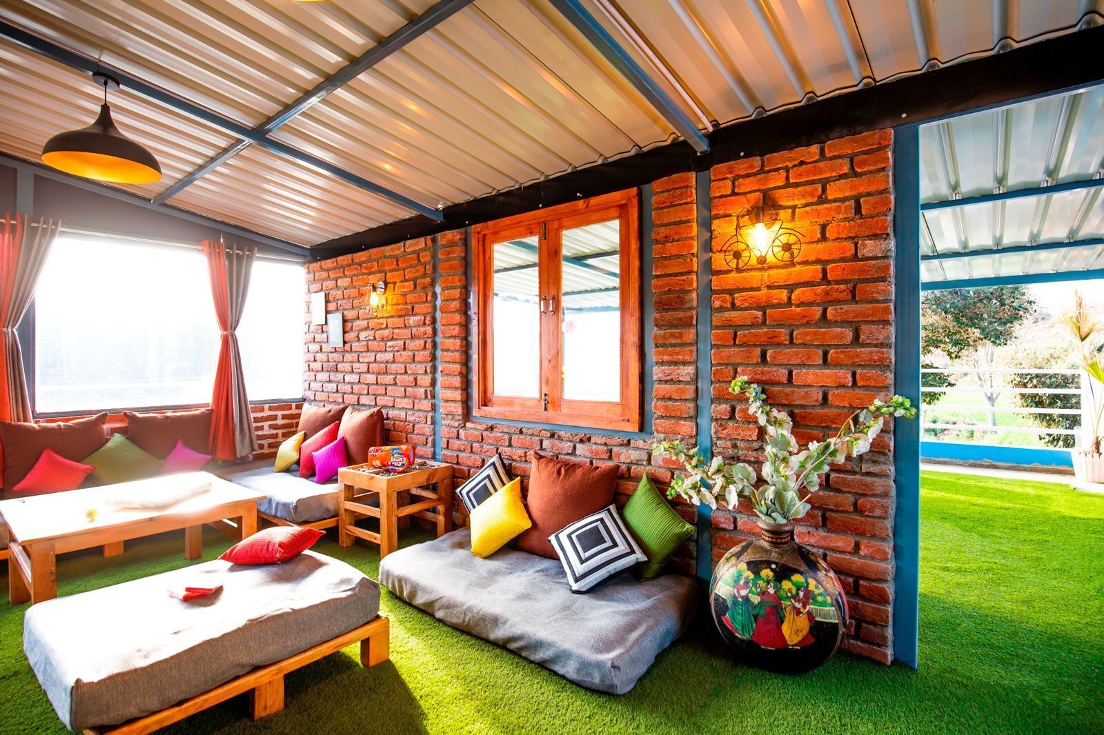 A cozy room with a brick wall, a wooden bench, and a table.