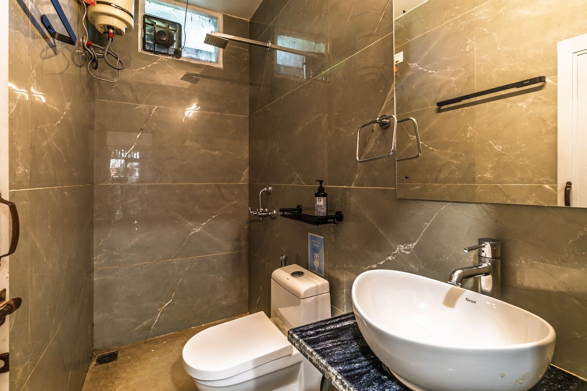 A bathroom with a toilet, sink, and shower.