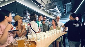 A bar area with a long counter, multiple cups, and glasses of beverages.