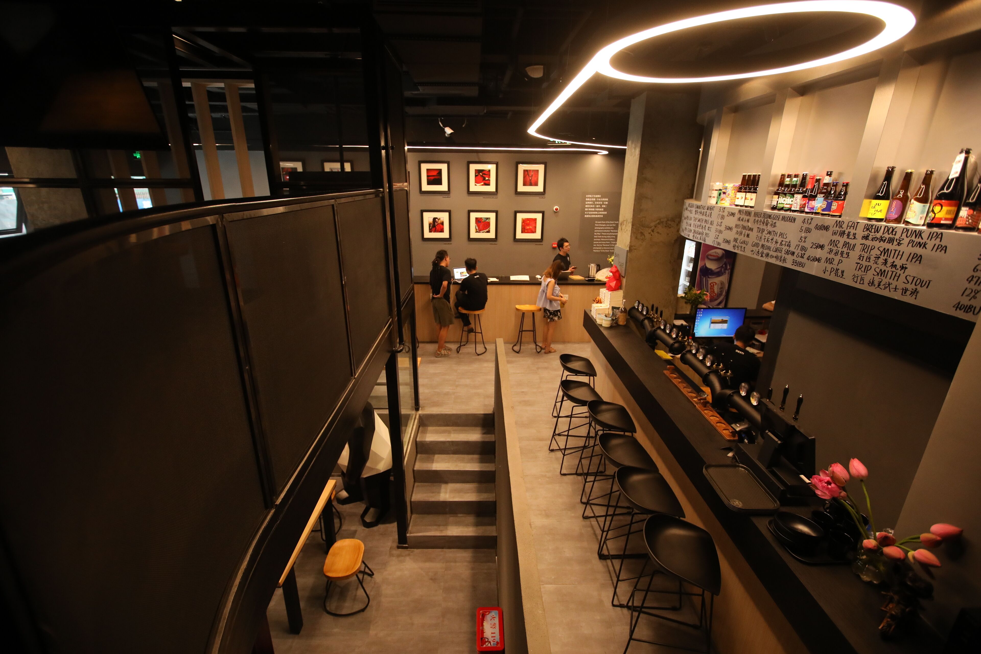 A bar area with stools, a counter, and a menu board.