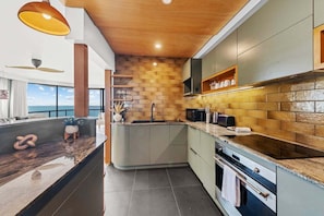 Fridge, microwave, oven, stovetop - 3BR Oceanfront Escape – Steps to Beach & Shops (City of Moreton Bay)