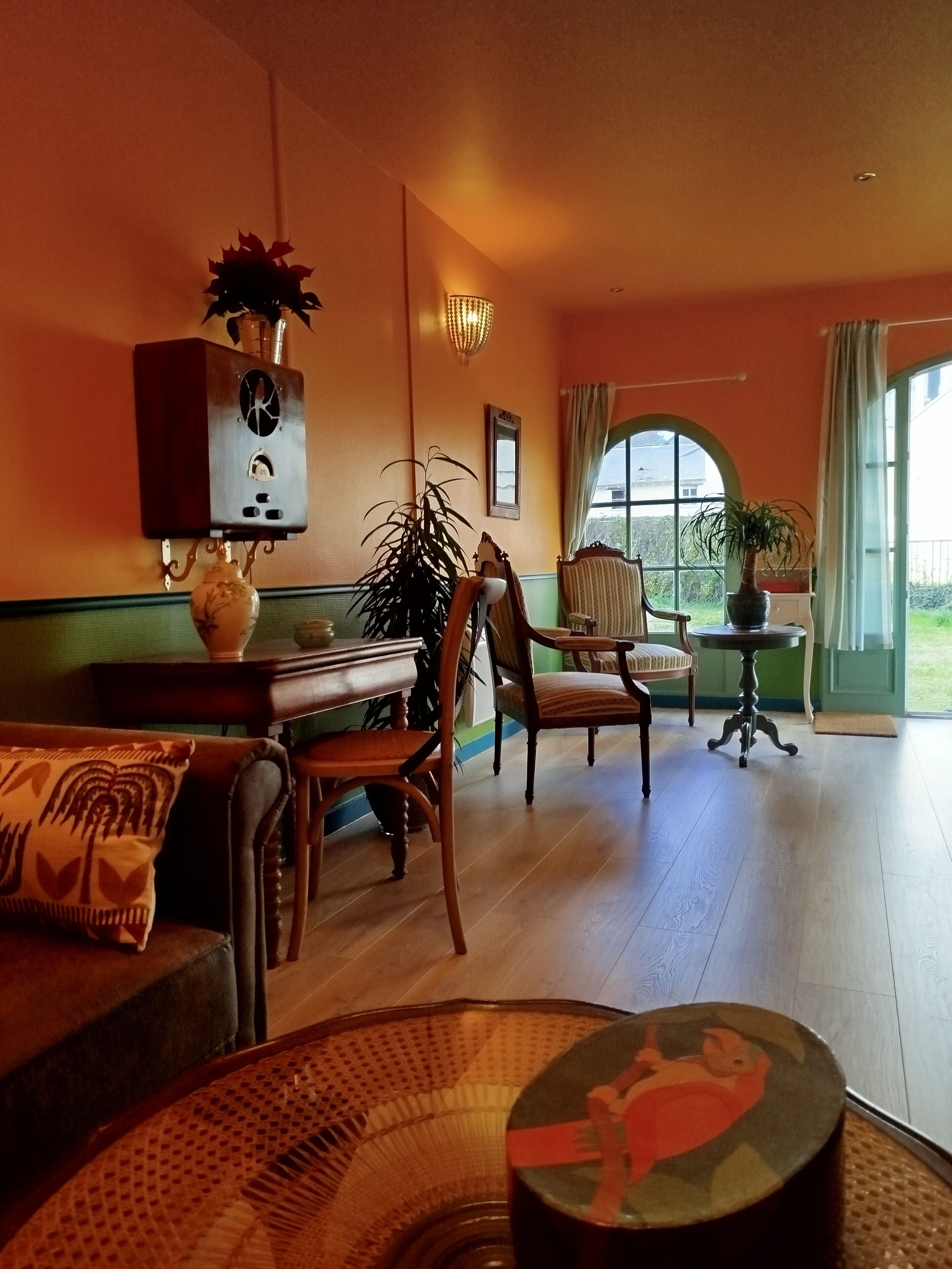 A cozy living room with a fireplace, a dining table, and comfortable seating.