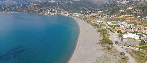 Rannalla, aurinkotuoleja, rantapyyhkeitä