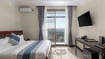Deluxe Suite, Balcony, City View | In-room safe, desk, laptop workspace, blackout drapes