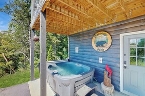 A wooden cabin with a hot tub, a wooden door, and a sign that reads "shaconage Oasis". - 1 Mi to Douglas Lake! Mtn-view Haven w/ Hot Tub (Sevierville)