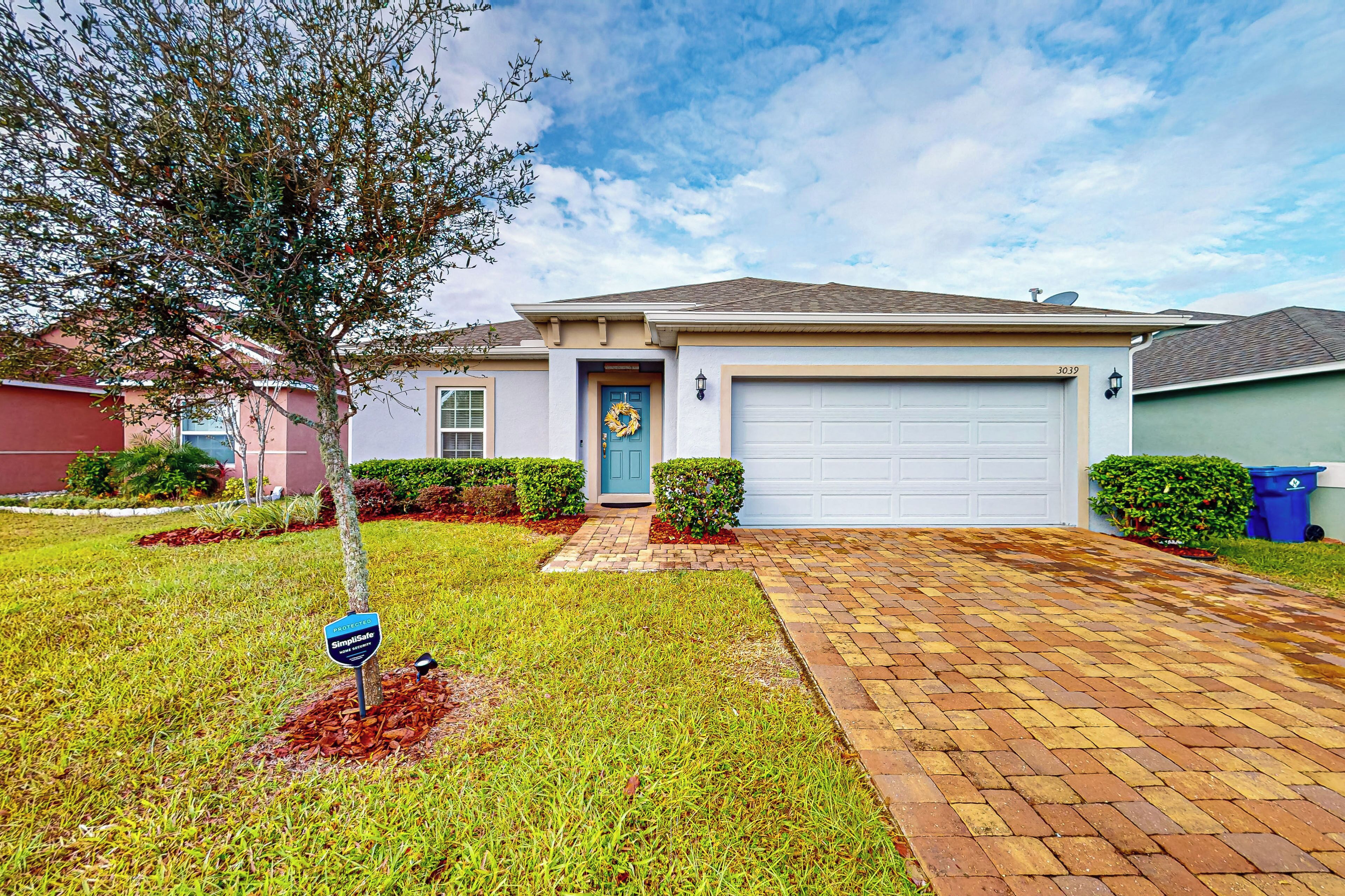 A residential house with a front yard, a driveway, and a garage.