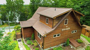 A two-story wooden cabin with a sloped roof, a front porch, and a small deck. - Hot Tub, Lake Views! All-season Hinsdale Haven (Hinsdale)