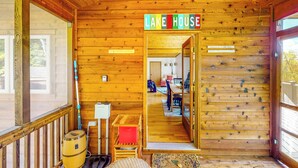A wooden cabin with a sign reading "LAKE HOUSE" and a visible dining area with chairs and a table. - Hot Tub, Lake Views! All-season Hinsdale Haven (Hinsdale)