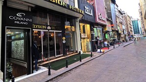 A hotel with a modern facade, a visible entrance, and a red carpet leading to the entrance. - ELYSİON HOTEL (İstanbul)