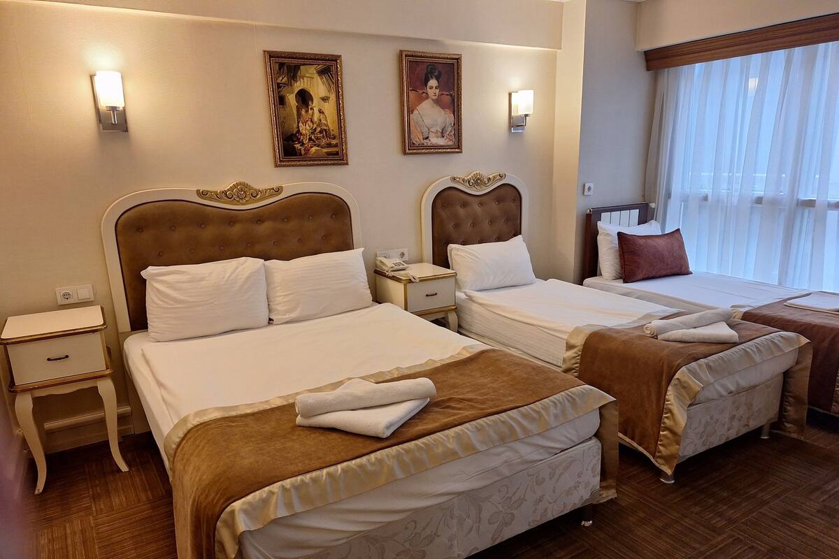 Standard Quadruple Room, City View | Premium bedding, minibar, iron/ironing board (on request), WiFi (free)