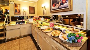 A buffet area with various food items and a painting on the wall. - ELYSİON HOTEL (İstanbul)