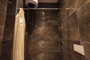 A shower area with a glass door, a towel rack, and a control panel on the wall. - Azzurra Studio 05 in Durr s (Durrës)