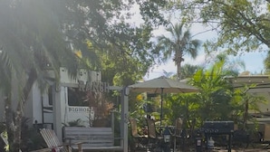 A paved pathway with a bench and a covered seating area. - Luxury rv lot 191 at River ranch rv resort golf cart included  NO RV INCLUDED (Lake Wales)