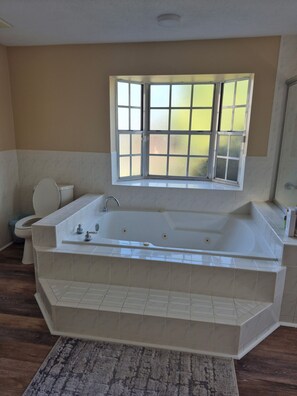 Jetted bath, towels, soap, toilet paper