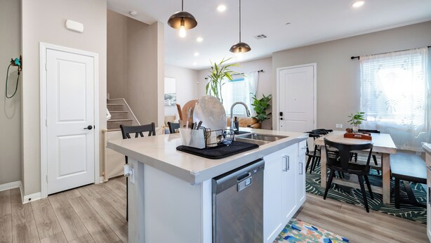 A modern kitchen with a central island, stainless steel appliances, and pendant lighting. - Spacious, Family-friendly Chula Vista 3BR + Children's Playroom+Pool & Park (Chula Vista)