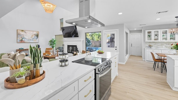 A modern kitchen with a central island, stainless steel appliances, and a large window. - 7BR 5BA w Pool, Hot Tub, Sport Court & Game Room (DeSoto)