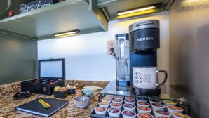 A coffee station with a Keurig machine, a coffee maker, and a variety of coffee pods. - Spacious 5-bdrm house in tranquil 7 Devils. Hottub & AC. < 1 mile to Hawksnest (Seven Devils)