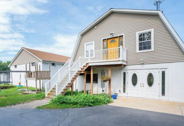 A two-story house with a front porch, a staircase, and a garage.