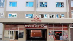 A multi-story building with a sign for PLM Palace Lodge. - PLM Palace Lodge (Durban)