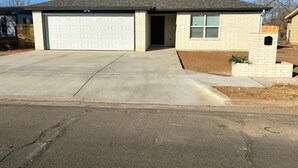 A single-story house with a garage, a small front porch, and a brick exterior. - Built in 2025 - In the heart of Lubbock (Lubbock)
