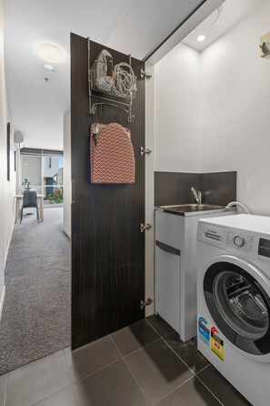 Appartement | Badkamer | Een haardroger, handdoeken, zeep, shampoo